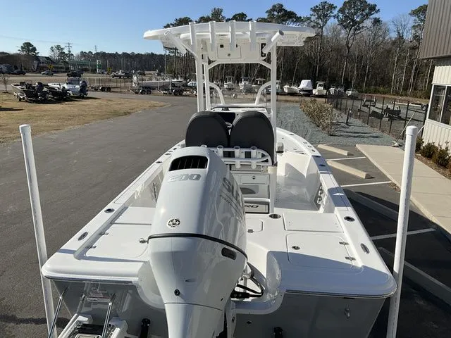 Slide: The Image of 2026 Sea Pro 230 Bay Boat with outboard motor, parked outdoors. - 3