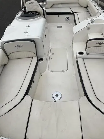 Slide: The Image of 2022 Stingray 212 boat interior with white seating. - 18