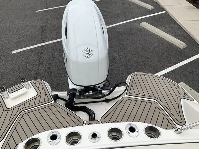 Slide: The Image of Stingray 212 boat 2022 with Suzuki outboard motor in parking lot. - 20