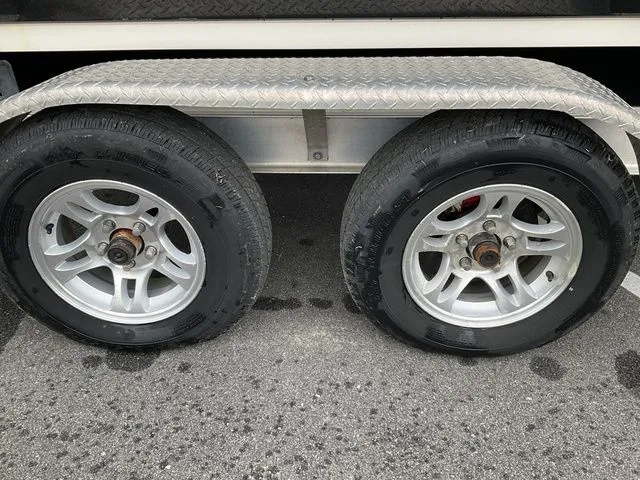 Slide: The Image of Dual trailer wheels of a 2022 Stingray 212 on asphalt. - 4