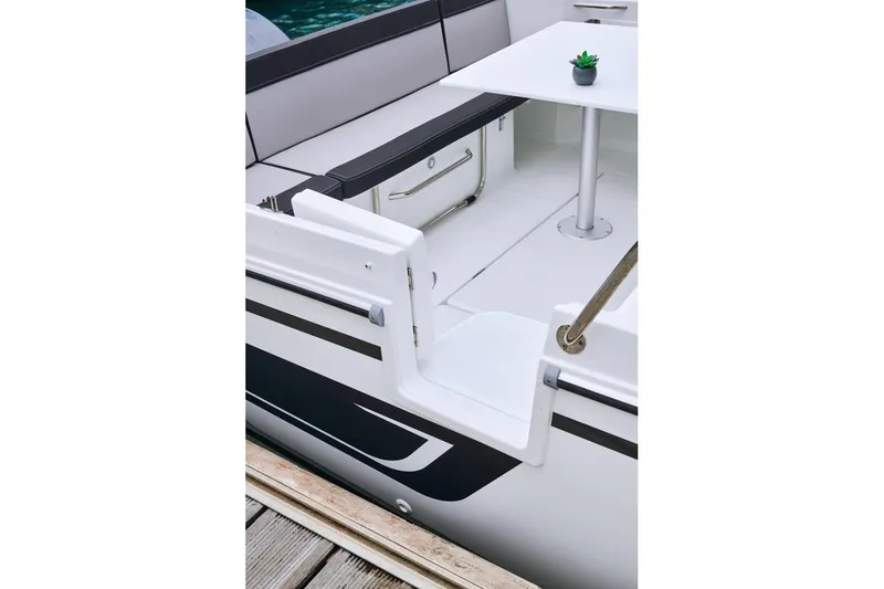 Slide: The Image of 2026 Jeanneau NC 795 Series 2 boat interior with seating and table. - 10