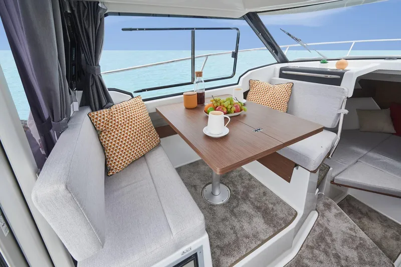 Slide: The Image of Interior of 2026 Jeanneau NC 795 Series 2 with dining area and sea view. - 14
