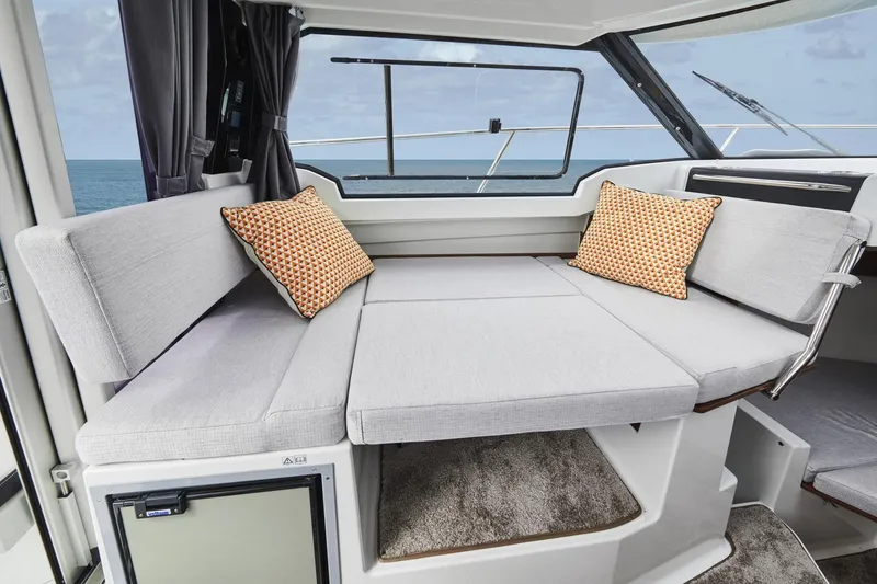 Slide: The Image of 2026 Jeanneau NC 795 Series 2 interior with cozy seating and ocean view. - 15