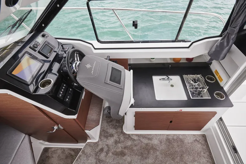 Slide: The Image of Interior of 2026 Jeanneau NC 795 Series 2 boat with helm and kitchenette. - 18