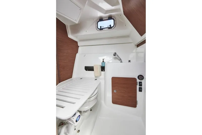Slide: The Image of 2026 Jeanneau NC 795 Series 2 boat interior with compact bathroom and wooden accents. - 21
