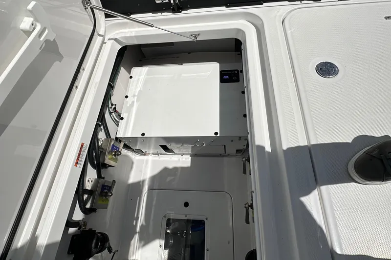 Slide: The Image of 2025 Blackfin 400 CC boat storage compartment with open hatch, showcasing interior details. - 5