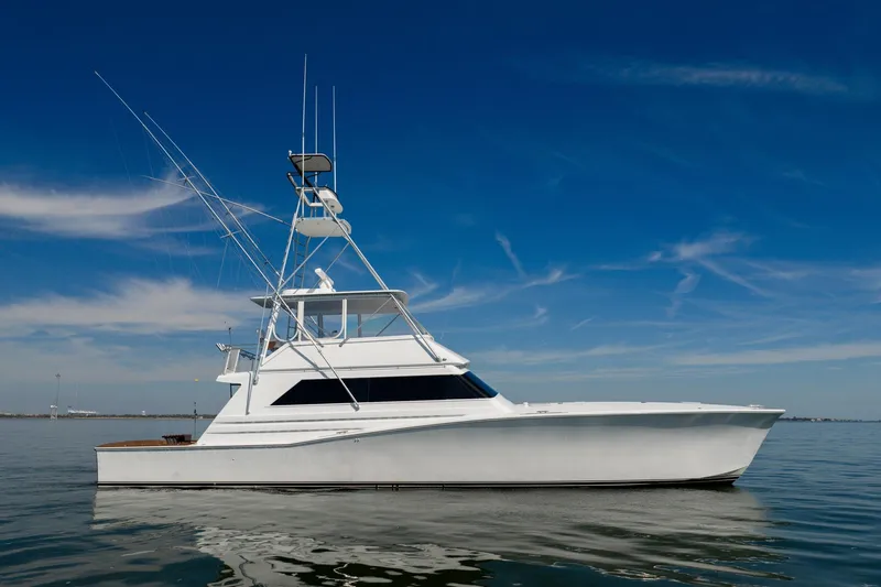 Slide: The Image of 1996 Jim Smith 60 Sportfish yacht on calm water under clear blue sky. - 1