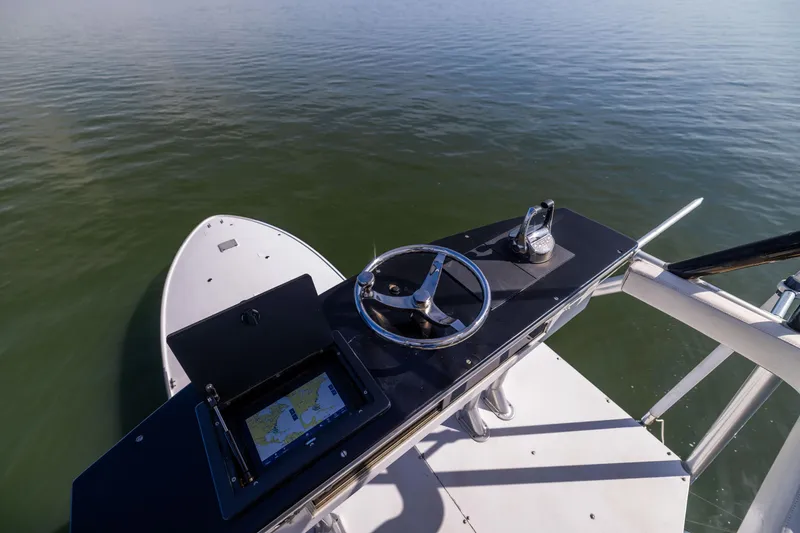 Slide: The Image of Helm of 1996 Jim Smith 60 Sportfish boat with navigation system on calm water. - 10