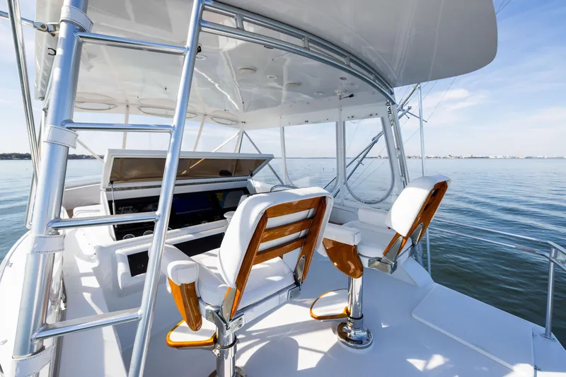 Slide: The Image of 1996 Jim Smith 60 Sportfish boat helm with ocean view, featuring sleek design and comfortable seating. - 11