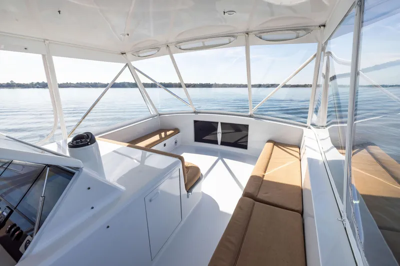 Slide: The Image of Interior view of 1996 Jim Smith 60 Sportfish yacht with spacious seating and panoramic windows. - 14