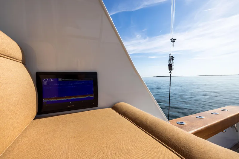 Slide: The Image of Jim Smith 60 Sportfish 1996 boat with Garmin display, ocean view, and fishing rod. - 19