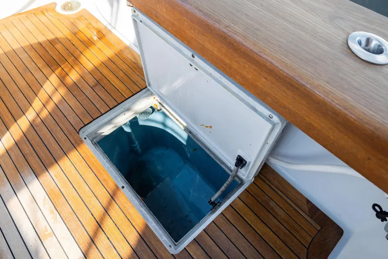 Slide: The Image of Open hatch on 1996 Jim Smith 60 Sportfish boat with wooden deck. - 22