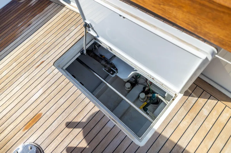 Slide: The Image of Open hatch on 1996 Jim Smith 60 Sportfish boat deck, revealing mechanical components. - 24