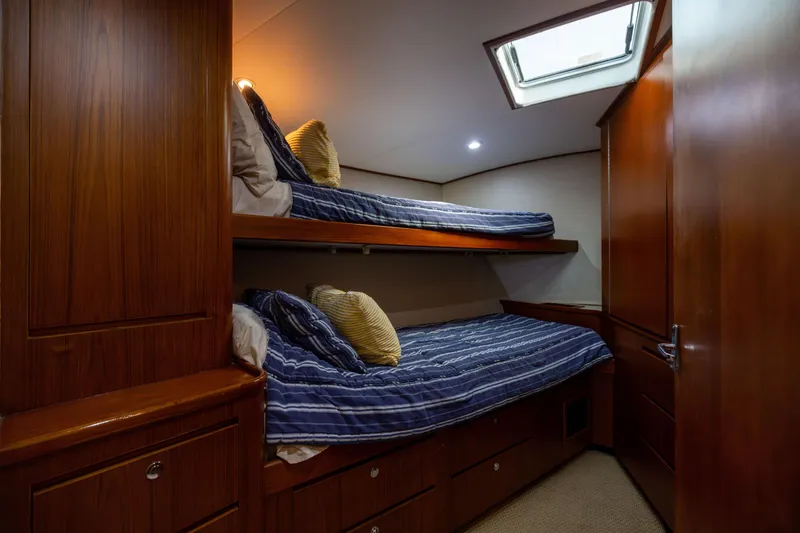 Slide: The Image of Bunk beds in a 1996 Jim Smith 60 Sportfish yacht cabin with wood paneling. - 41