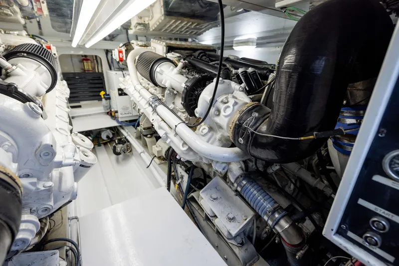 Slide: The Image of Engine room of a 1996 Jim Smith 60 Sportfish boat, showcasing detailed machinery. - 43