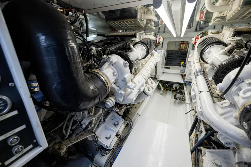 Slide: The Image of Engine room of a 1996 Jim Smith 60 Sportfish boat, showcasing dual engines. - 44