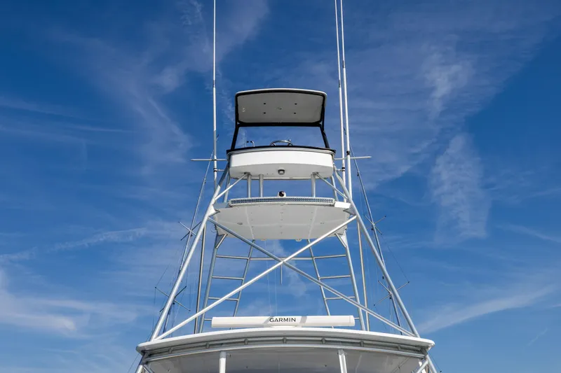 Slide: The Image of Jim Smith 60 Sportfish 1996 boat tower against a clear blue sky. - 9