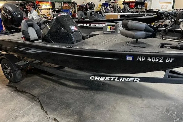 Slide: The Image of 2023 Crestliner XF 179 boat in showroom, black exterior, on trailer. - 8