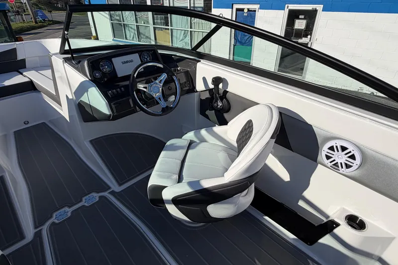 Slide: The Image of 2026 Monterey M-225 boat interior with steering wheel and captain's chair. - 11