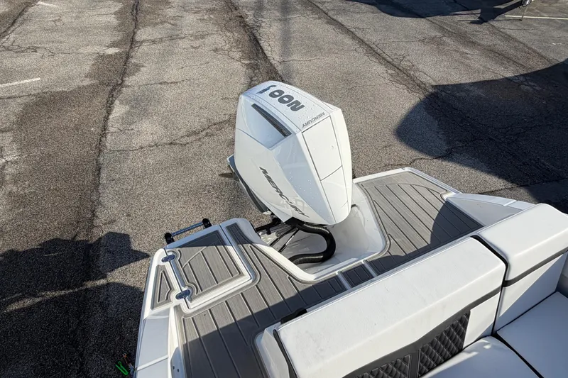 Slide: The Image of 2026 Monterey M-225 boat with Mercury outboard engine on a textured deck. - 14