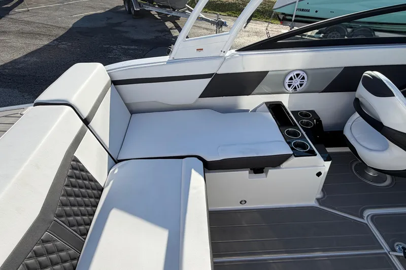 Slide: The Image of 2026 Monterey M-225 boat interior with white seating, cup holders, and modern design. - 15