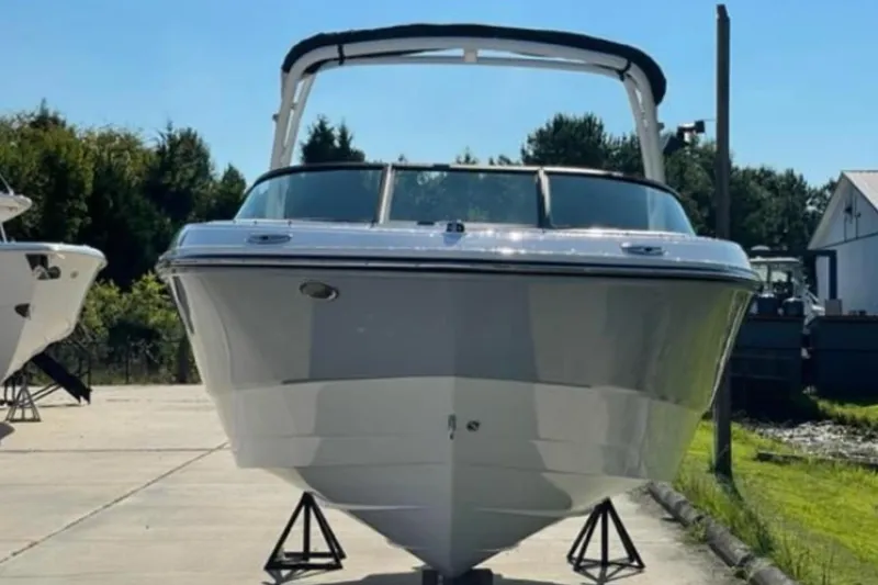 Slide: The Image of 2026 Monterey M-225 boat on display, front view, outdoors on a sunny day. - 2