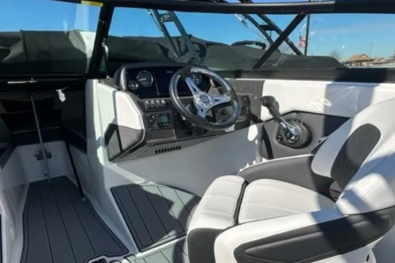 Slide: The Image of Interior of 2026 Monterey M-225 boat, featuring sleek steering and modern controls. - 6