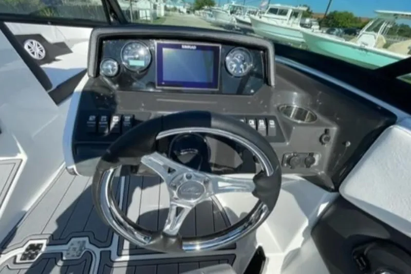 Slide: The Image of 2026 Monterey M-225 boat dashboard with steering wheel and control panel. - 7
