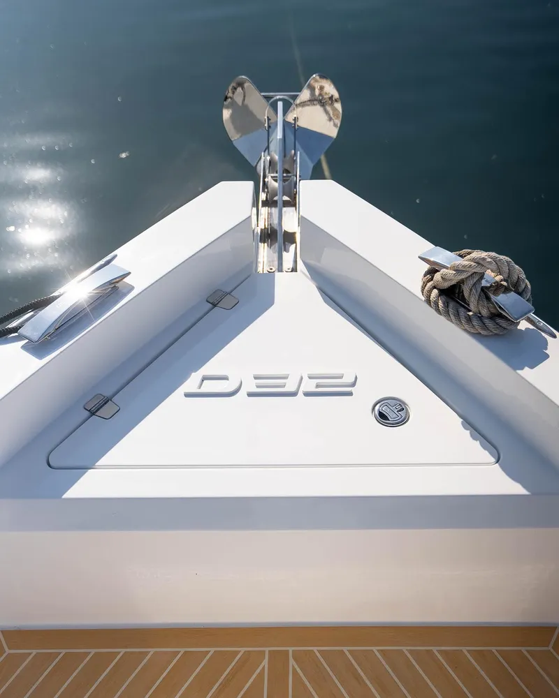 Slide: The Image of 2024 De Antonio Yachts D32 OPEN bow with anchor, sleek design on calm water. - 4