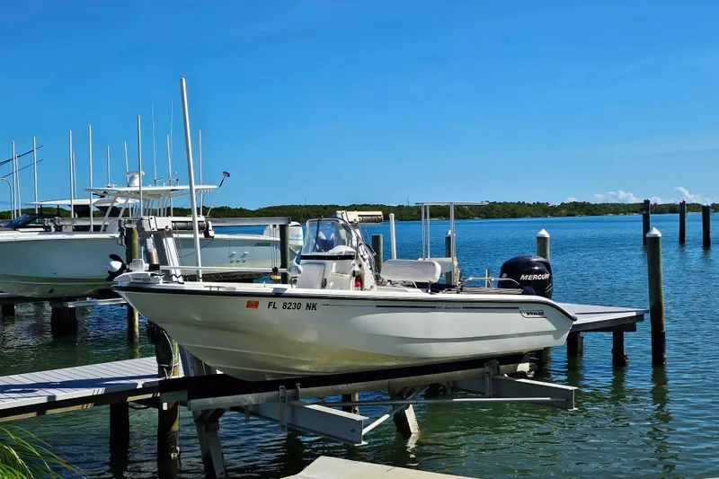 The Image of 2006 Boston Whaler 180 Dauntless boat docked by serene waterfront. - 0