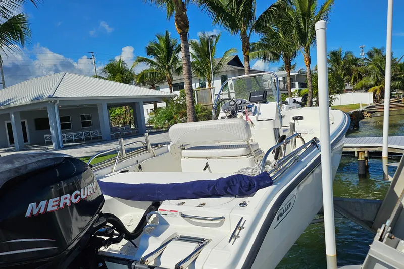 Slide: The Image of 2006 Boston Whaler 180 Dauntless boat docked near tropical waterfront. - 7