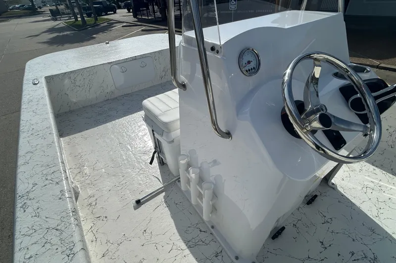 Slide: The Image of 2026 Coastal Skiff 212 boat interior with steering wheel and seating. - 12