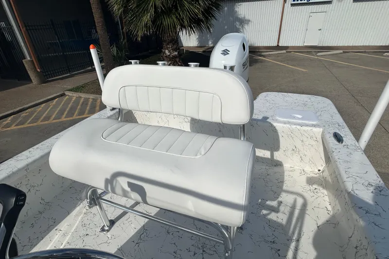 Slide: The Image of 2026 Coastal Skiff 212 boat interior with white cushioned seating and marbled flooring. - 13