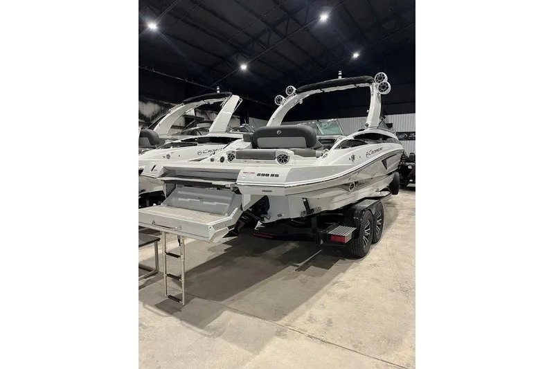 The Image of 2026 Crownline 298 SS boat in showroom, rear view with swim platform and ladder. - 1