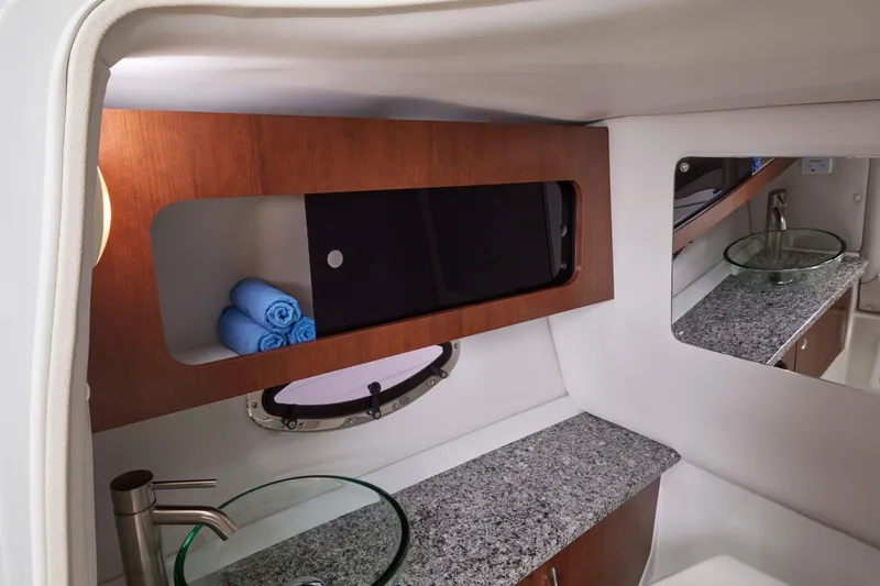 Slide: The Image of Luxurious 2026 Crownline 298 SS cabin interior with modern sink and storage. - 11