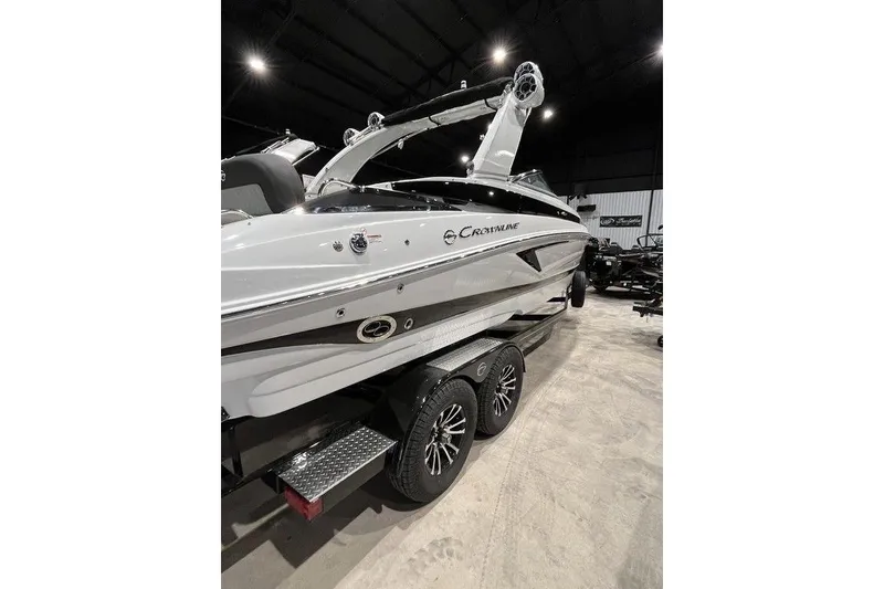 Slide: The Image of 2026 Crownline 298 SS boat on trailer in indoor showroom. - 3