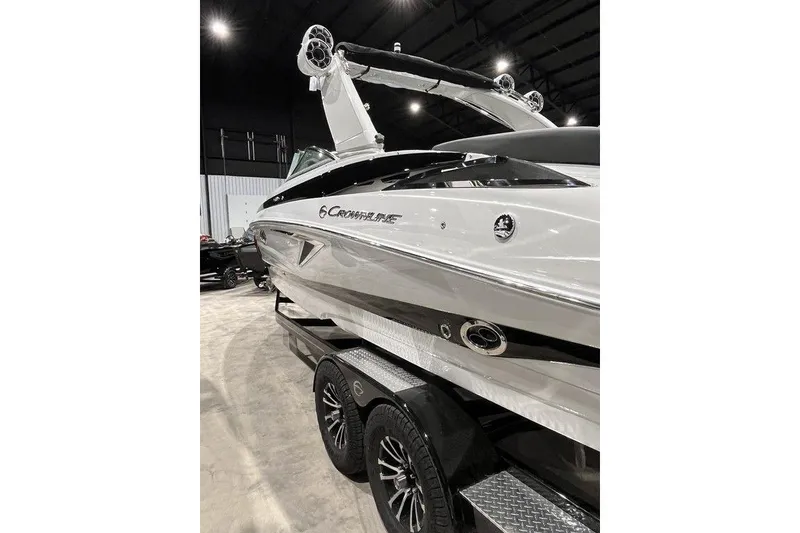 Slide: The Image of 2026 Crownline 298 SS boat on trailer in indoor showroom. - 4