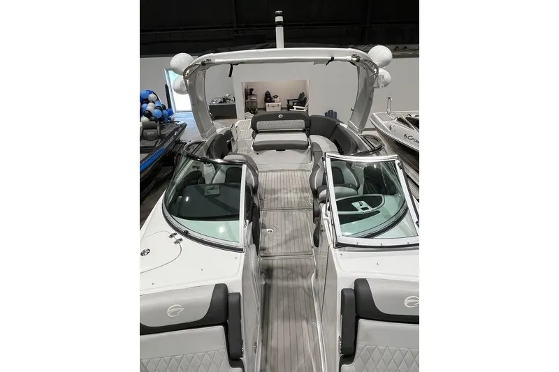 Slide: The Image of 2026 Crownline 298 SS boat with sleek design and spacious seating. - 7