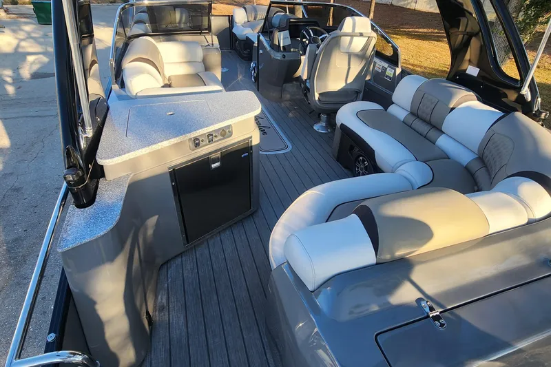 Slide: The Image of 2023 Avalon Excalibur 25' boat interior with luxurious seating and modern amenities. - 11