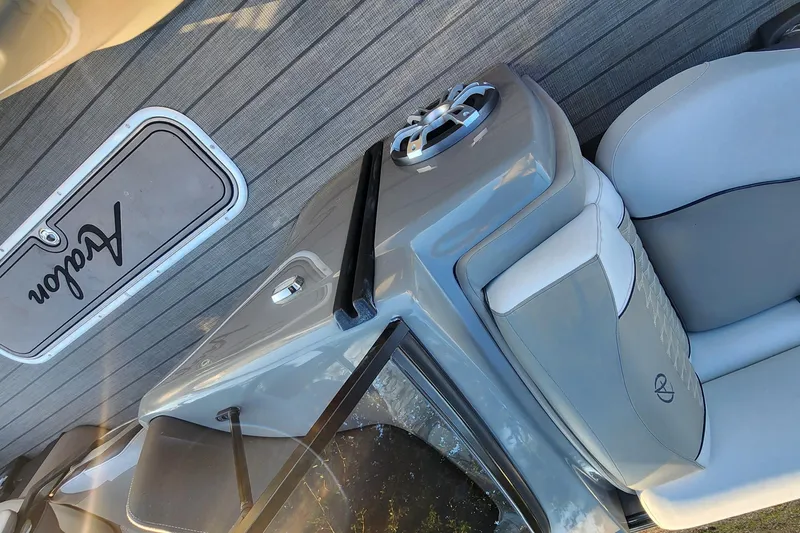 Slide: The Image of 2023 Avalon Excalibur 25' boat interior with sleek gray seating and modern design. - 19