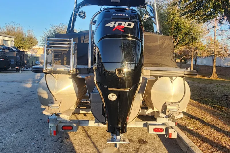 Slide: The Image of 2023 Avalon Excalibur 25' boat with powerful 400R Verado engine, parked outdoors. - 24