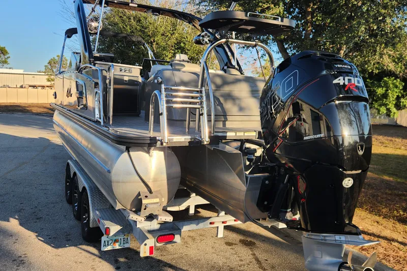 Slide: The Image of 2023 Avalon Excalibur 25' pontoon boat with Mercury 400R engine on trailer. - 3