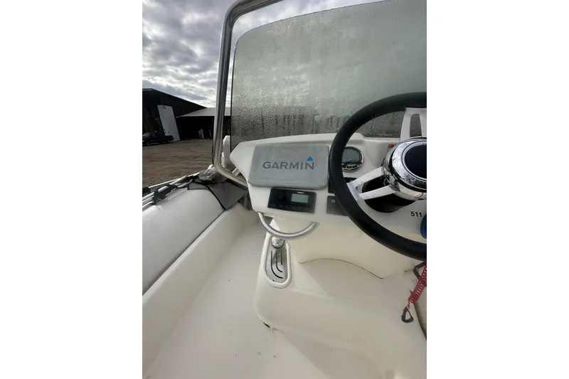 Slide: The Image of 2023 Zodiac N-ZO 680 boat dashboard with Garmin navigation system and steering wheel. - 11
