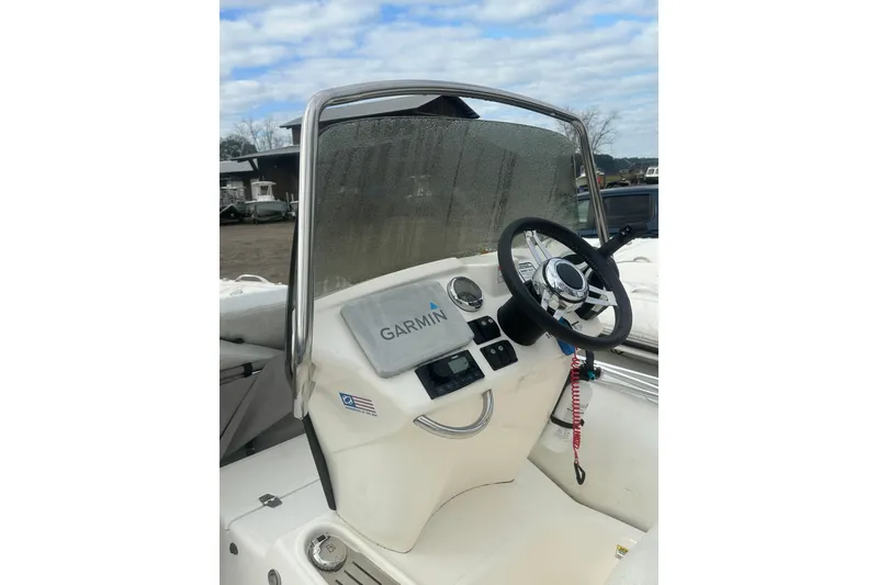 Slide: The Image of 2023 Zodiac N-ZO 680 boat console with Garmin navigation system and steering wheel. - 12