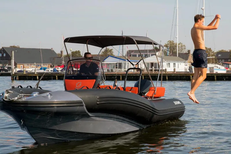 Slide: The Image of Man jumps off Zodiac N-ZO 680 boat into water. - 15