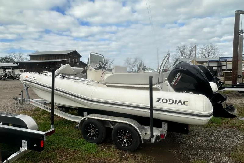 Slide: The Image of 2023 Zodiac N-ZO 680 inflatable boat on trailer, outdoor setting, cloudy sky. - 2