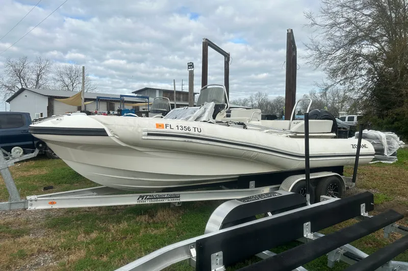 Slide: The Image of 2023 Zodiac N-ZO 680 boat on trailer, parked outdoors under cloudy sky. - 3