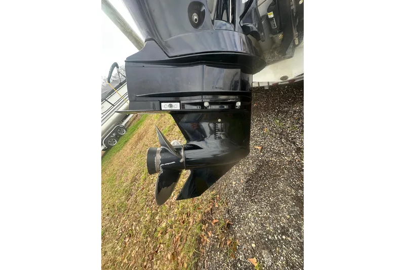 Slide: The Image of Close-up of a 2023 Zodiac N-ZO 680 boat motor propeller on gravel and grass. - 9