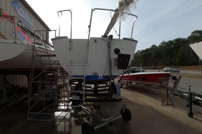 Slide: The Image of 1985 Oday 272 sailboat on trailer, parked outdoors near other boats. - 12