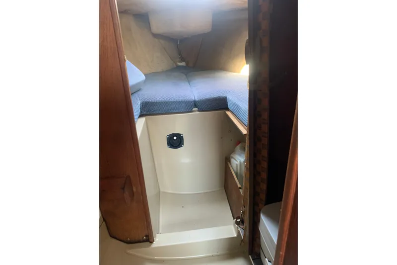 Slide: The Image of Interior cabin of 1985 Oday 272 sailboat with blue cushions and storage space. - 17